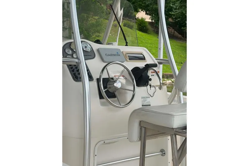 Slide: The Image of 2005 Aquasport 2100 Center Console boat helm with Garmin navigation system. - 6