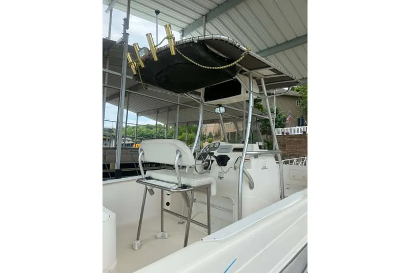Slide: The Image of 2005 Aquasport 2100 Center Console boat with T-top and fishing rod holders. - 7