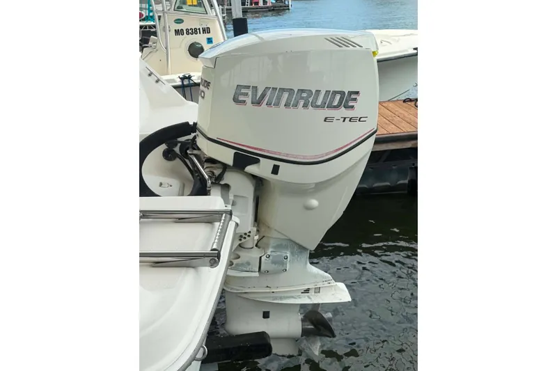 Slide: The Image of 2005 Aquasport 2100 Center Console with Evinrude E-TEC outboard motor docked. - 3