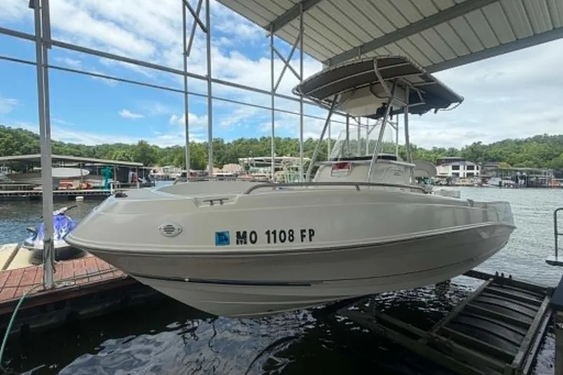 The Image of 2005 Aquasport 2100 Center Console boat docked at a marina. - 1