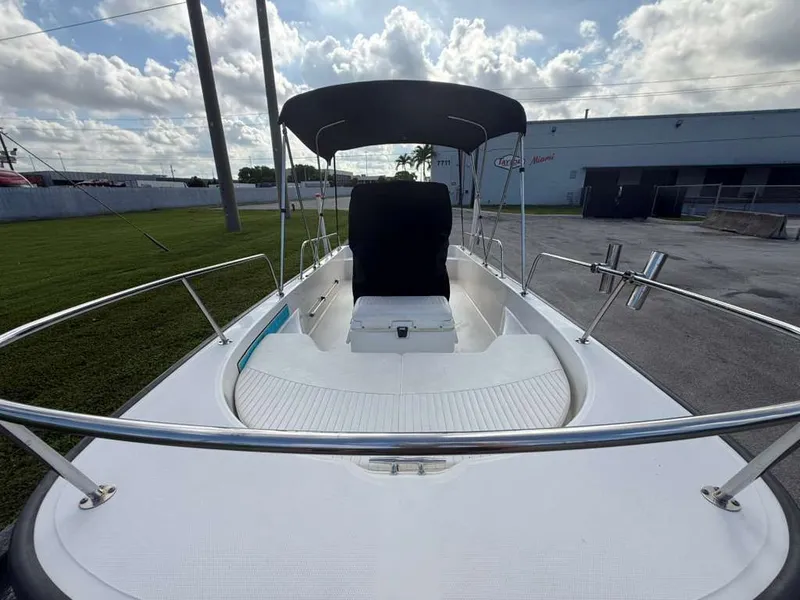 Slide: The Image of A 2016 Boston Whaler 170 Montauk with a sunshade, parked on a lot. - 6