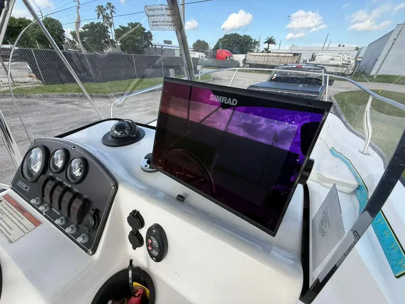 Slide: The Image of The image shows the cockpit of a 2016 Boston Whaler 170 Montauk with a Simrad display. - 4