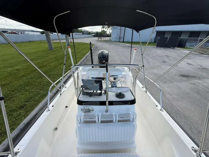 Slide: The Image of The image shows the cockpit of a Boston Whaler 170 Montauk with a black sunshade. - 18