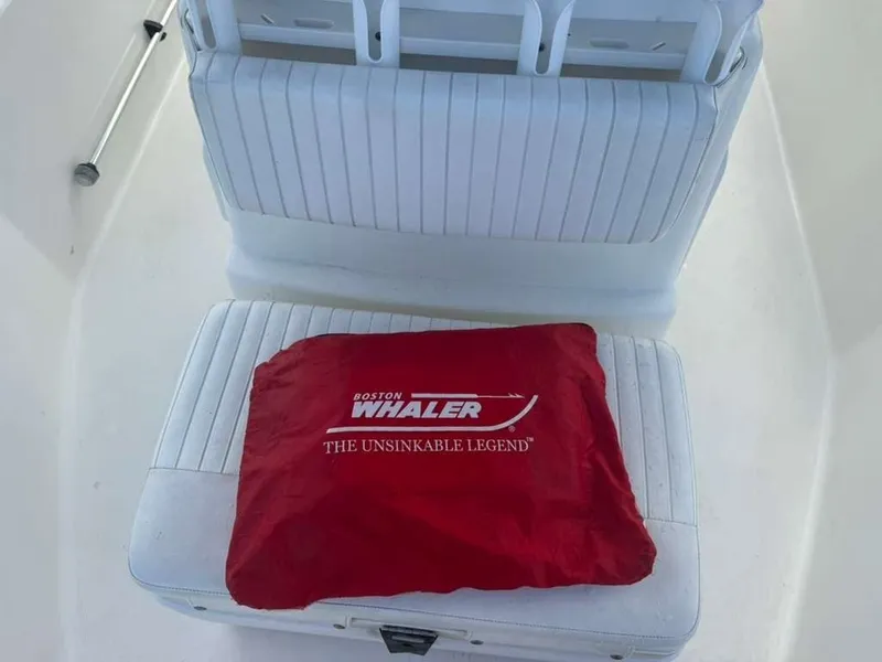 Slide: The Image of A white seat with a red Boston Whaler cushion on it. - 20