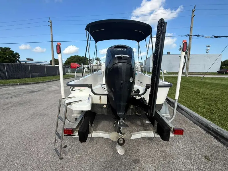 Slide: The Image of The image shows a 2016 Boston Whaler 170 Montauk boat on a trailer. - 12