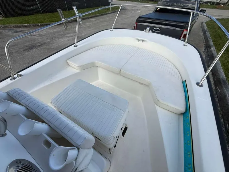 Slide: The Image of The image shows the cockpit of a 2016 Boston Whaler 170 Montauk with white seating. - 19