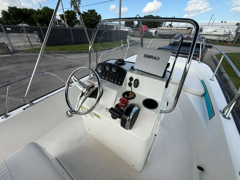 Slide: The Image of The image shows the cockpit of a 2016 Boston Whaler 170 Montauk with steering and instruments. - 3