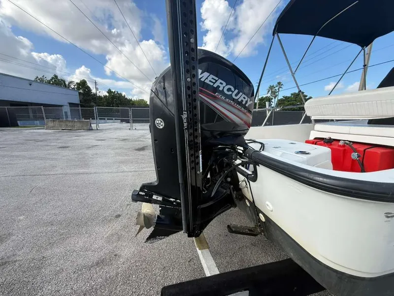 Slide: The Image of A 2016 Boston Whaler 170 Montauk with a Mercury outboard motor, parked in a lot. - 10