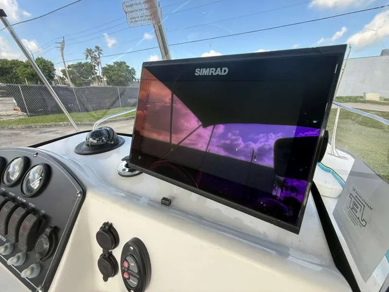 Slide: The Image of The image shows the cockpit of a Boston Whaler 170 Montauk with a Simrad display. - 2