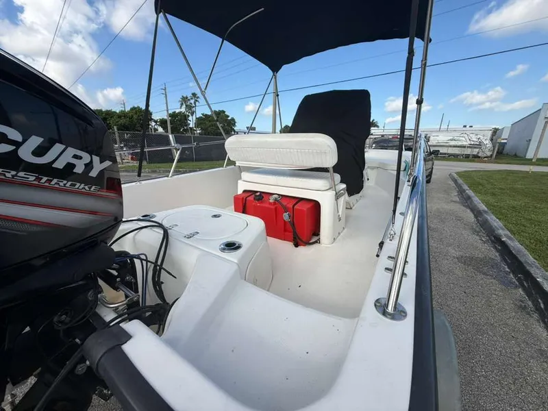 Slide: The Image of A 2016 Boston Whaler 170 Montauk with a Mercury engine, lounge seat, and red fuel tank. - 9