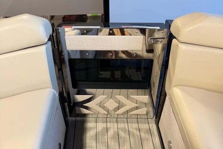 Slide: The Image of Interior view of 2026 Balise Halo 26C Twin boat with beige seating and patterned flooring. - 25