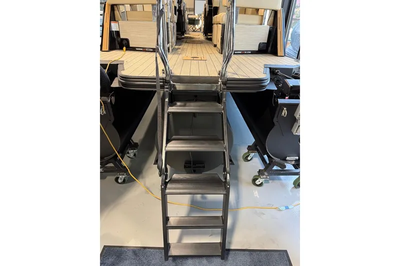 Slide: The Image of Stairs leading to the deck of a 2026 Balise Halo 26C Twin boat. - 22