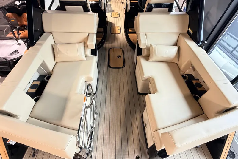 Slide: The Image of Luxurious interior of 2026 Balise Halo 26C Twin boat with beige seating and wood flooring. - 3