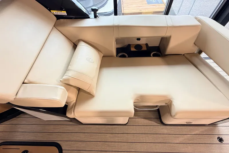 Slide: The Image of Luxurious seating on the 2026 Balise Halo 26C Twin boat, featuring beige upholstery and cup holders. - 4