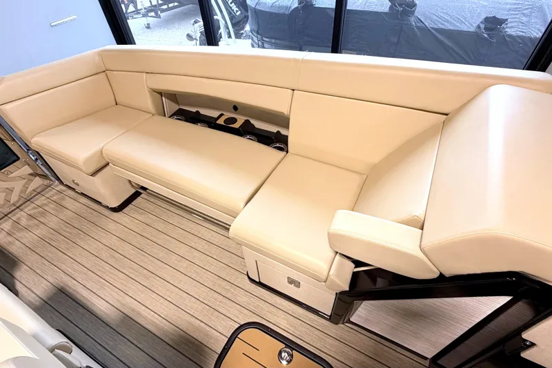 Slide: The Image of The image shows a luxurious beige upholstered seating area on a boat with wooden flooring. - 20