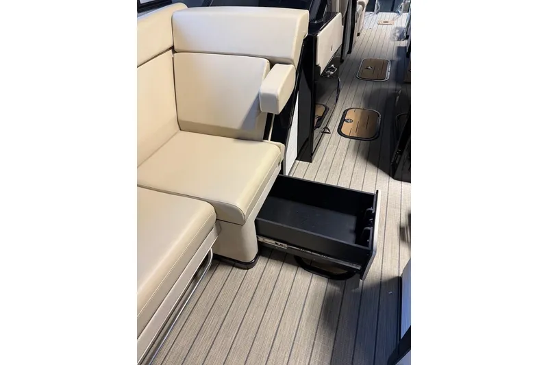 Slide: The Image of Interior of 2026 Balise Halo 26C Twin with beige seating and open storage drawer. - 20