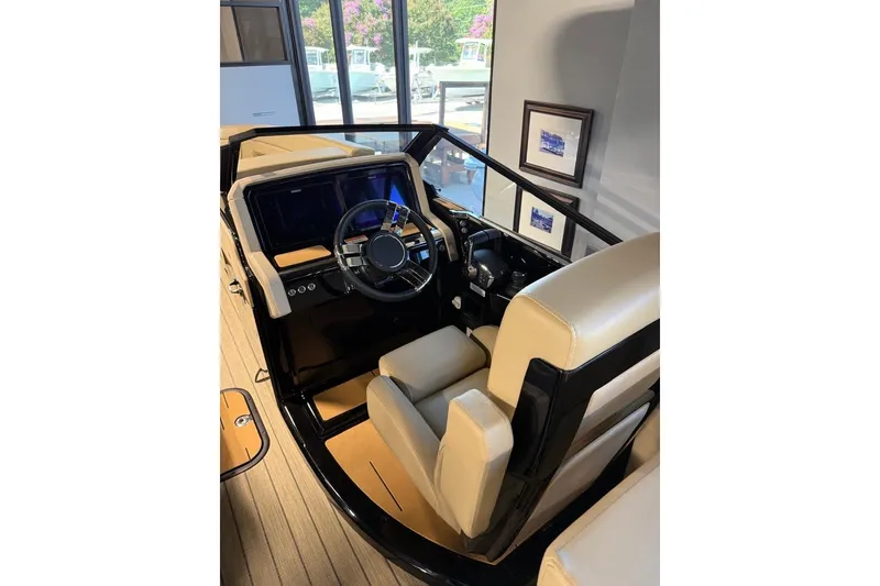 Slide: The Image of Interior of 2026 Balise Halo 26C Twin boat with modern steering and beige seating. - 8