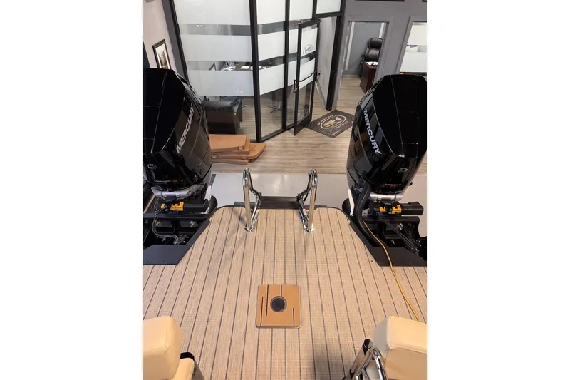 Slide: The Image of Balise Halo 26C Twin 2026 boat with dual Mercury engines in showroom setting. - 23