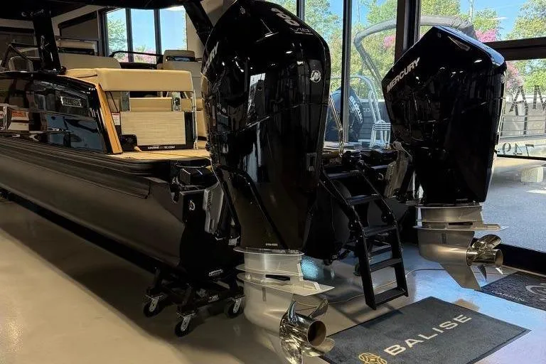 Slide: The Image of 2026 Balise Halo 26C Twin boat with dual outboard motors in showroom. - 2