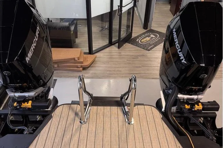 Slide: The Image of Balise Halo 26C Twin 2026 boat with dual Mercury engines in showroom setting. - 27