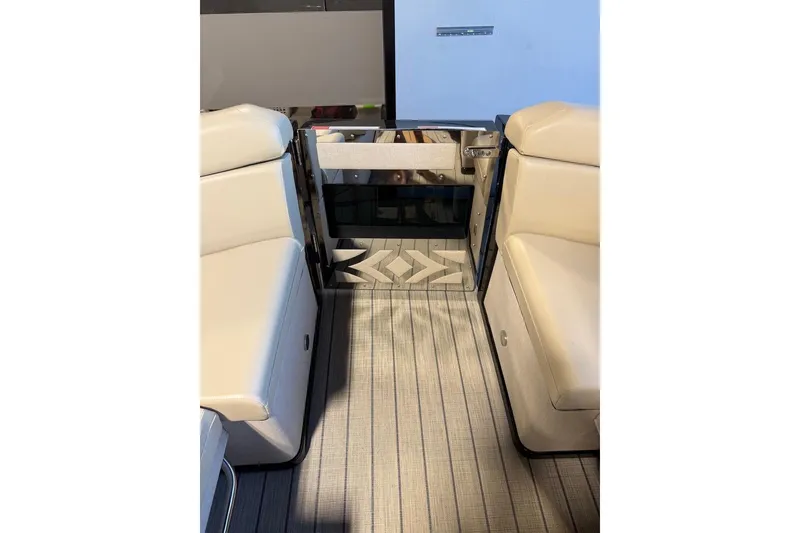 Slide: The Image of Interior view of 2026 Balise Halo 26C Twin boat with beige seating and patterned flooring. - 19