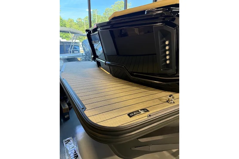 Slide: The Image of 2026 Balise Halo 26C Twin boat with sleek black design and wooden deck. - 3