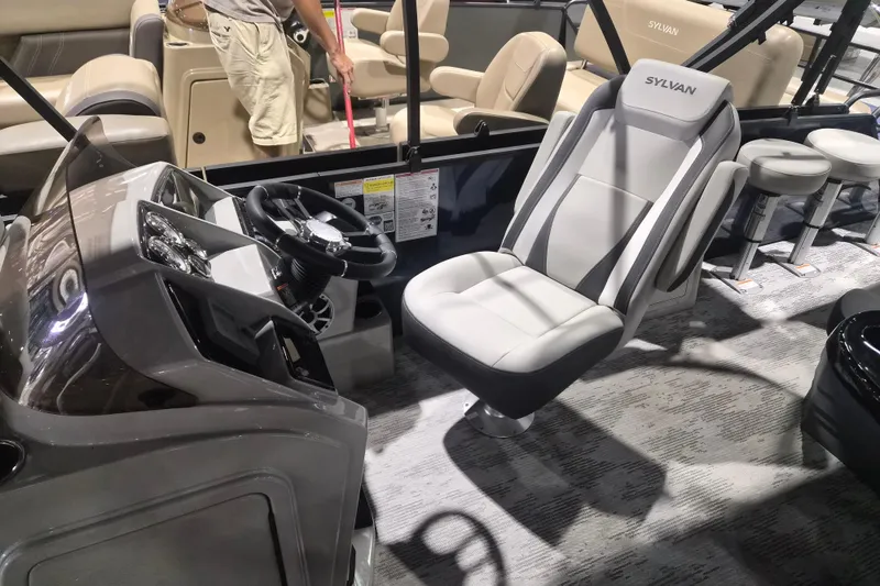 Slide: The Image of 2026 Sylvan R-22 LZ DH boat interior with modern seating and steering console. - 6