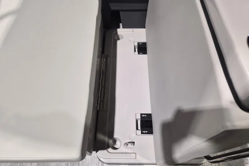 Slide: The Image of Interior seating detail of 2026 Sylvan R-22 LZ DH boat, showcasing storage compartment. - 17