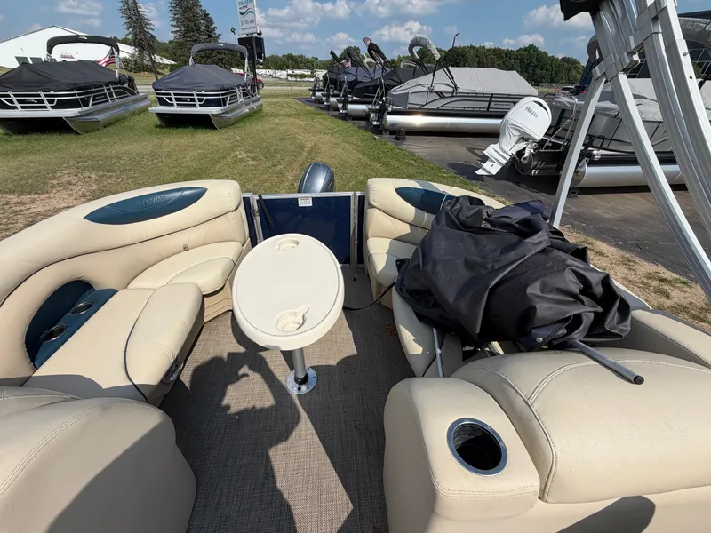 Slide: The Image of Interior of a 2018 Sylvan Mirage 8522 LZ Pontoon with beige seating and a table. - 6