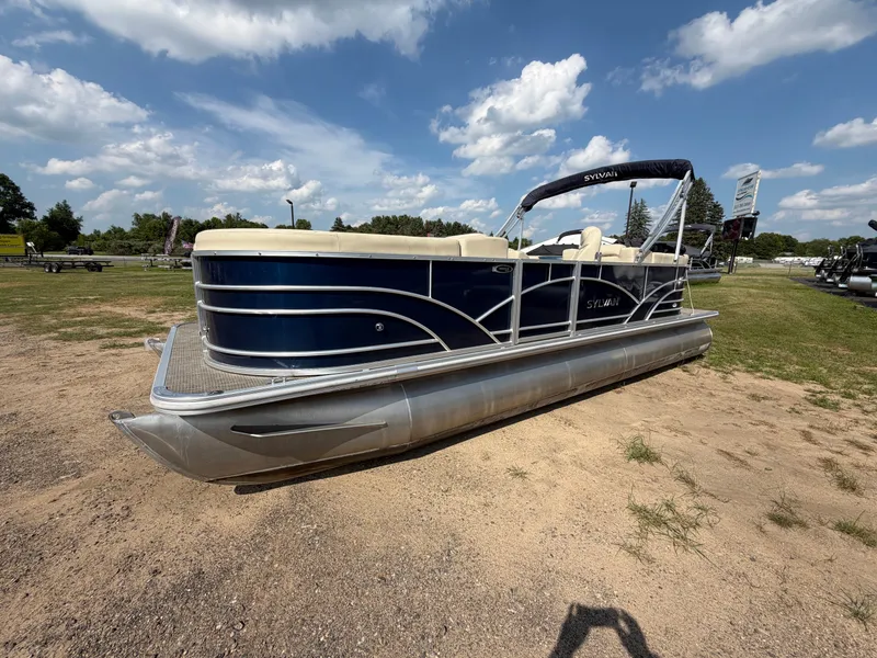 The Image of 2018 Sylvan Mirage 8522 LZ Pontoon on dry land with blue hull and beige interior. - 1