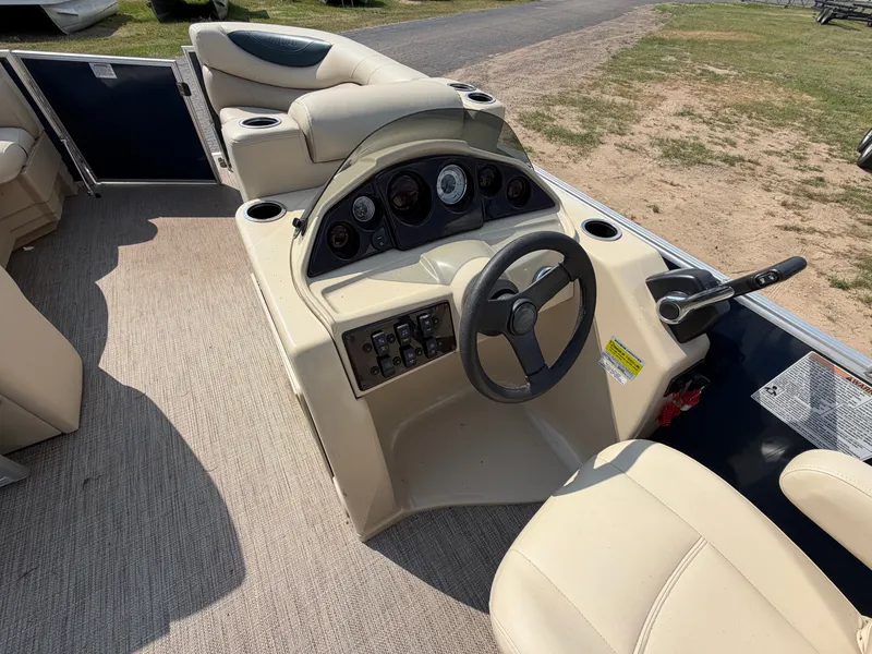 Slide: The Image of The image shows the cockpit of a 2018 Sylvan Mirage 8522 LZ Pontoon with beige seating. - 7