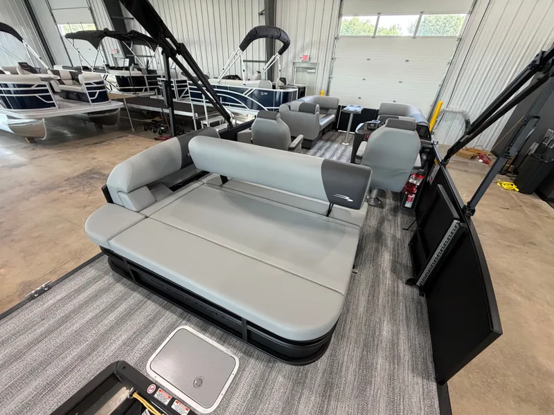 Slide: The Image of Interior of a Bennington S Series 22 SSB pontoon boat with gray seating in a showroom. - 6