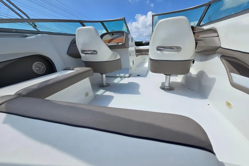 Slide: The Image of Interior of a 2000 Cobalt 246 boat with white seating and blue sky background. - 19