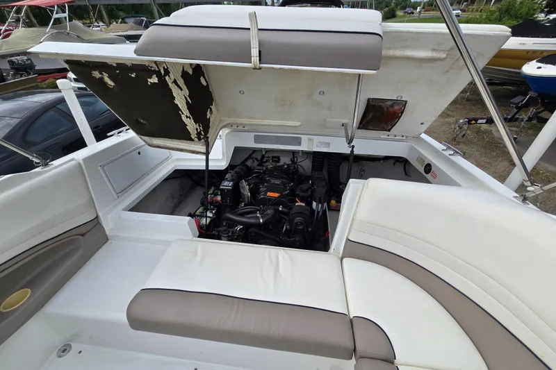 Slide: The Image of Open engine compartment of a 2000 Cobalt 246 boat, showcasing interior details. - 33