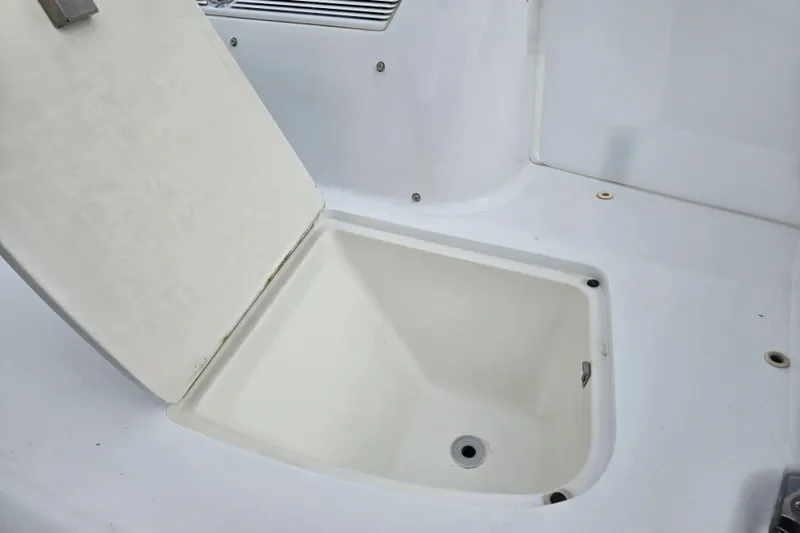 Slide: The Image of Open storage compartment on a 2000 Cobalt 246 boat, showcasing interior space. - 21