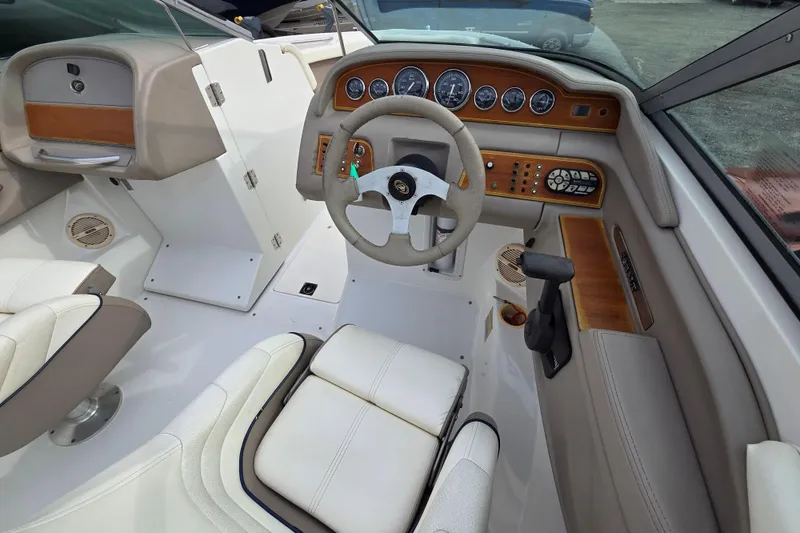 Slide: The Image of Interior of a 2000 Cobalt 246 boat featuring a steering wheel and control panel. - 10