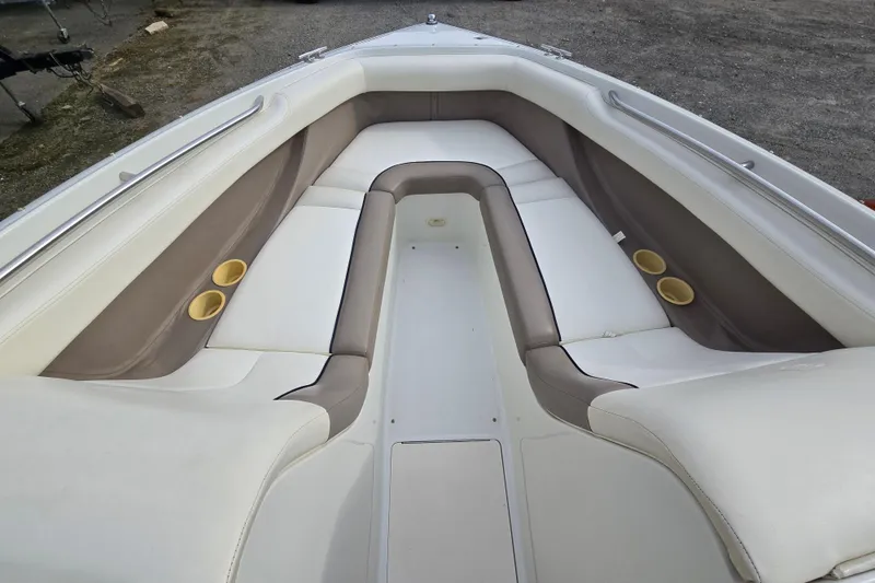 Slide: The Image of Interior of a 2000 Cobalt 246 boat with cushioned seating and cup holders. - 17
