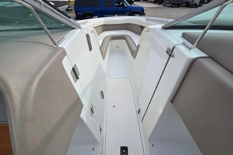 Slide: The Image of Interior view of a 2000 Cobalt 246 boat, featuring beige seating and white deck. - 15
