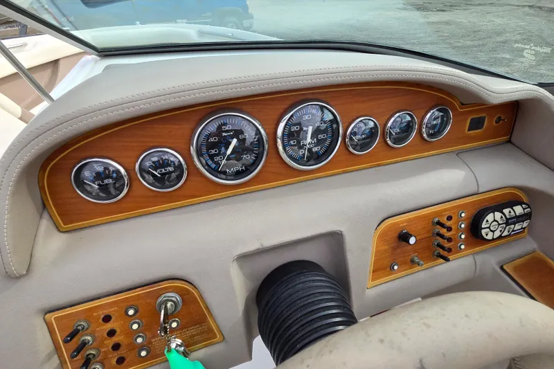 Slide: The Image of Dashboard of a 2000 Cobalt 246 boat with wood paneling and gauges. - 9