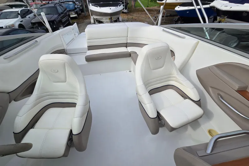 Slide: The Image of Interior of a 2000 Cobalt 246 boat with white and beige seating. - 14