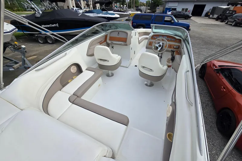 Slide: The Image of Interior of a 2000 Cobalt 246 boat with white and beige seating. - 11