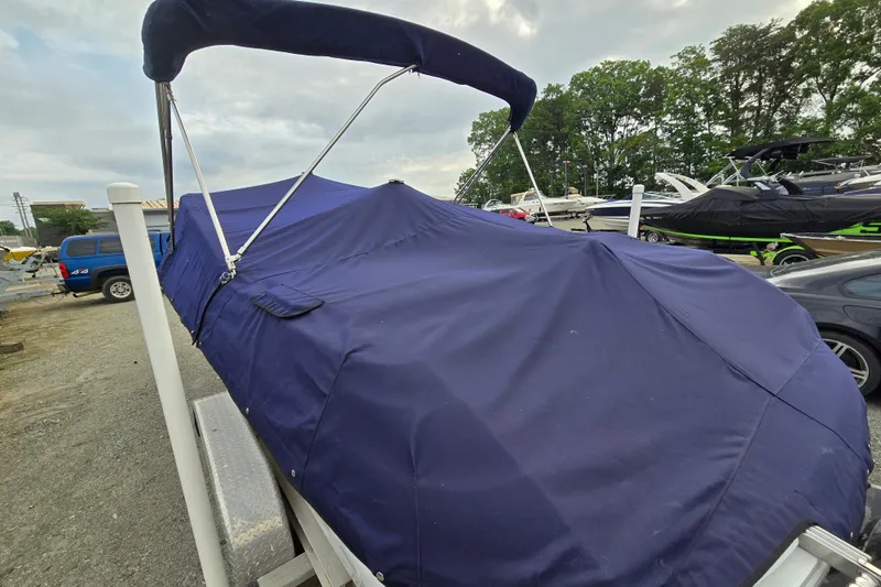 Slide: The Image of Covered 2000 Cobalt 246 boat on trailer, surrounded by other boats and vehicles. - 6