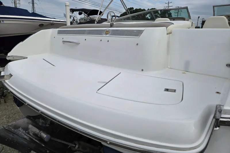 Slide: The Image of Rear view of a 2000 Cobalt 246 boat, showcasing its sleek white deck design. - 20