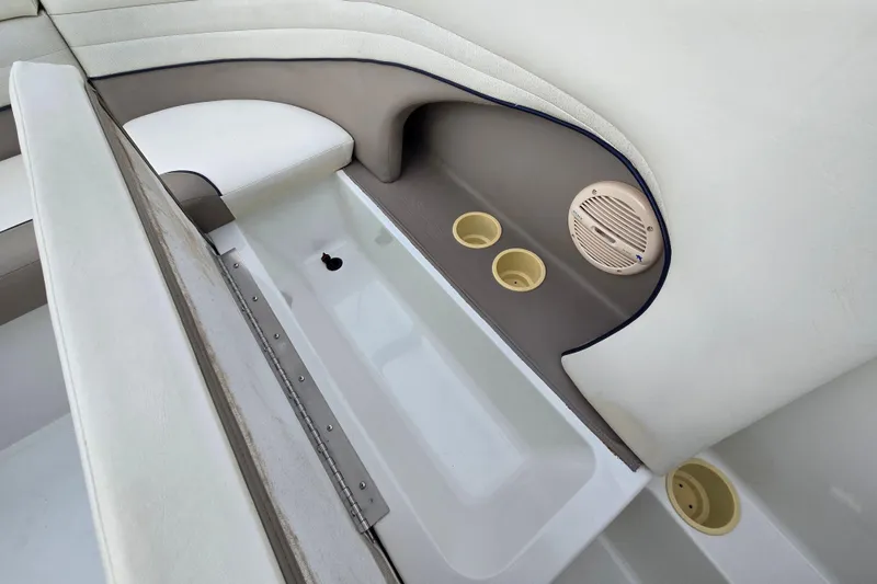 Slide: The Image of Interior of a 2000 Cobalt 246 boat featuring seating, cup holders, and speaker. - 34