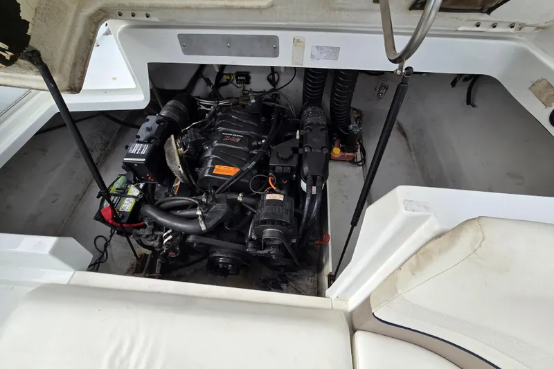Slide: The Image of Engine compartment of a 2000 Cobalt 246 boat, showcasing the motor and components. - 29