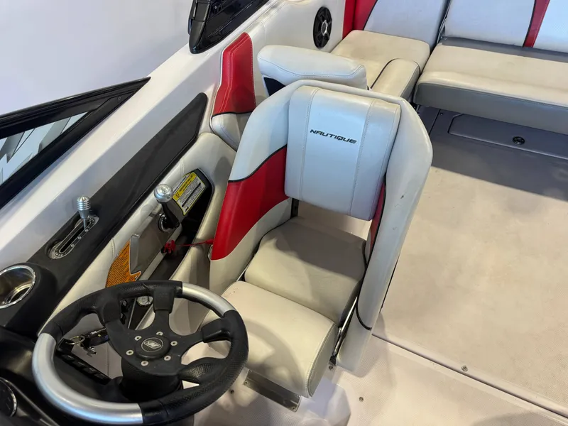 Slide: The Image of Interior of a 2011 Nautique Super Air Nautique 210 with white and red seating. - 20