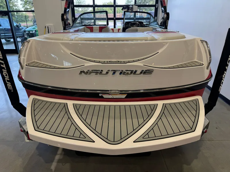 Slide: The Image of The image shows the rear of a 2011 Super Air Nautique 210 boat with a stylish design. - 8