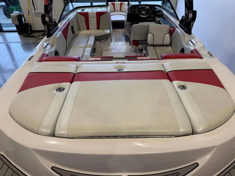 Slide: The Image of Interior of a 2011 Nautique Super Air Nautique 210 with red and white seating. - 9