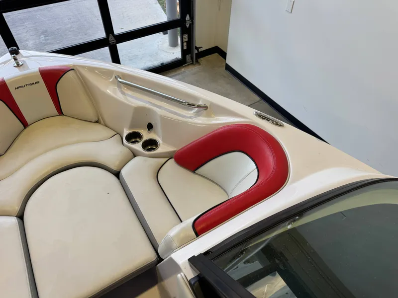 Slide: The Image of Interior view of a 2011 Nautique Super Air Nautique 210 with white and red seating. - 17