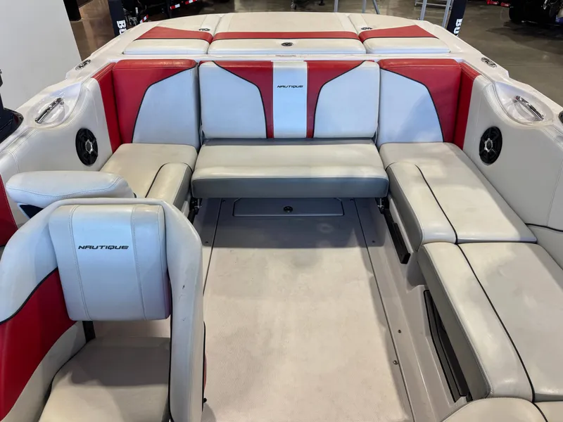 Slide: The Image of Interior of a 2011 Nautique Super Air Nautique 210 with red and gray seating. - 21